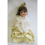 A Heubach Koppelsdorf bisque socket head character doll, with brown glass sleeping eyes, open mouth,