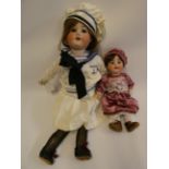 Two bisque socket head dolls, comprising a Hermann Steiner sailor doll, with brown glass sleeping