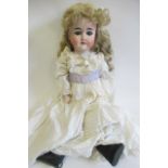 A Gebruder Knoch bisque socket head doll, with blue glass sleeping eyes, open mouth, teeth,