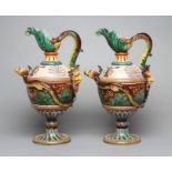 A PAIR OF MAIOLICA PEDESTAL EWERS, c.1900, of ovoid form with acanthus lip, bi-furcated snake's head