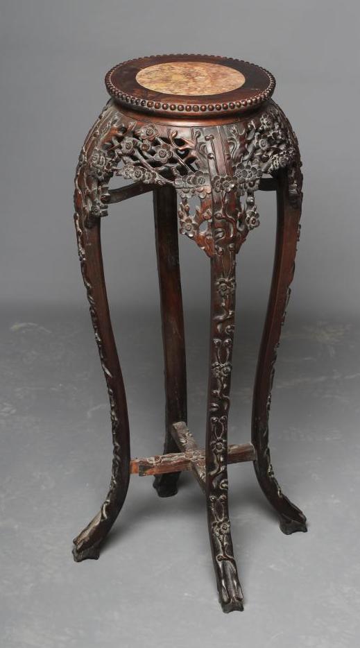 A CHINESE HARDWOOD JARDINIERE STAND, c.1900, the beaded edge circular top with veined red marble