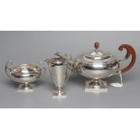 A THREE PIECE TEA SERVICE, maker James Ramsey, Sheffield 1929 (jug 1926), of squat globular form