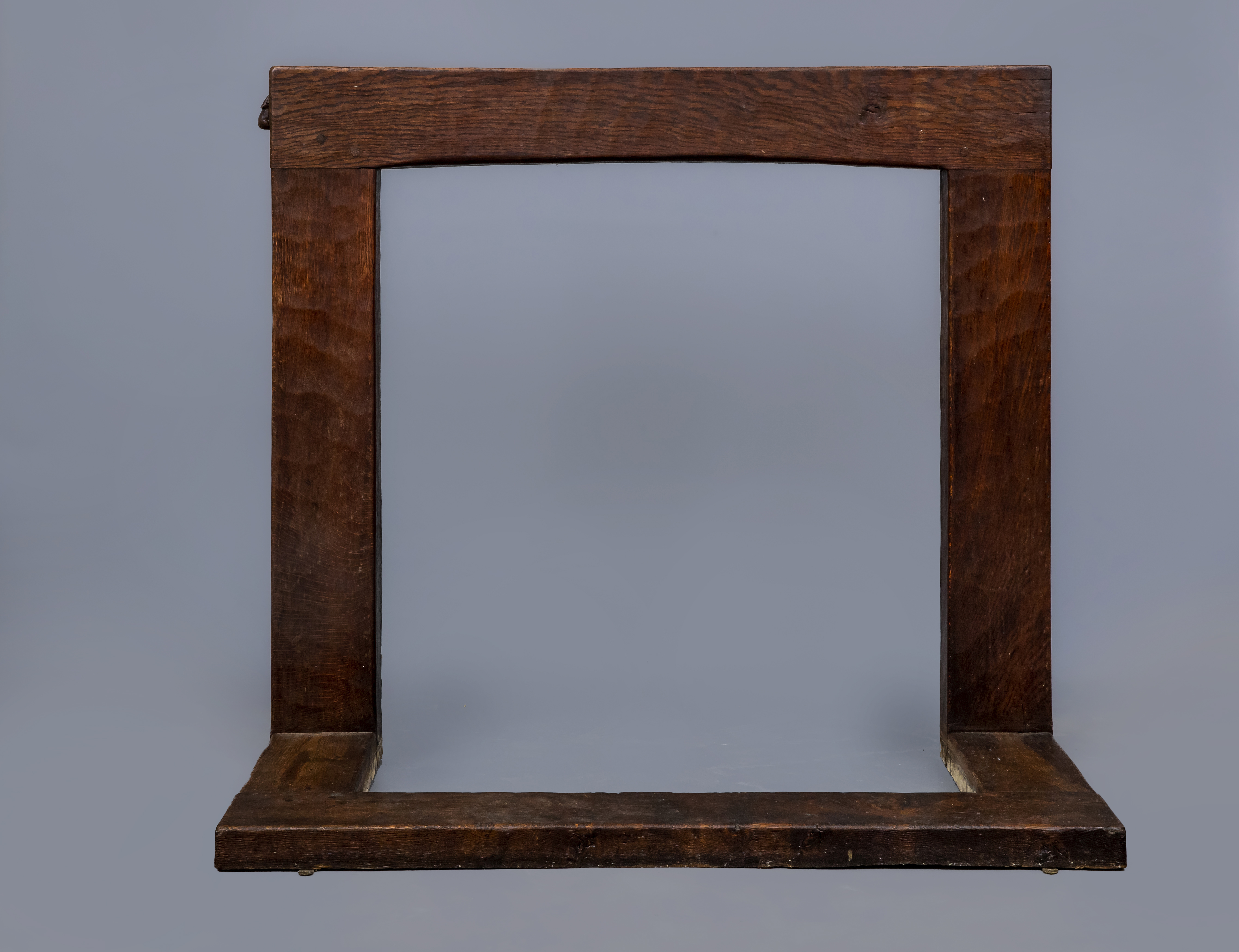 A ROBERT THOMPSON ADZED OAK FIRE SURROUND, c.1930's, of plain square section with mildly arched