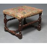 AN JOINED OAK STOOL, late 17th century, the oblong seat with contemporary Turkey work, on wrythen