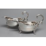 A PAIR OF SAUCEBOATS, maker Jenkins & Timm, Sheffield 1924, of shaped oval form with double C scroll
