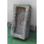 A SANDSTONE TROUGH of rough hewn oblong form, 31 1/2" x 16 1/2" x 9" (Est. plus 24% premium inc.