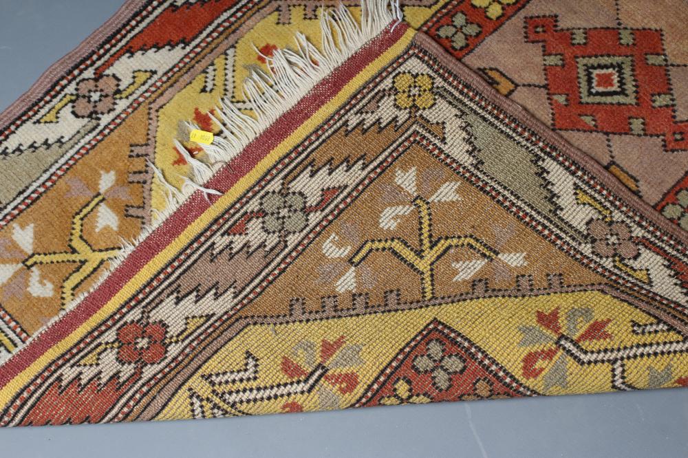 A KAZAK TYPE RUG, the oblong field with central rust coloured gul and similar border, on a bold - Image 3 of 3