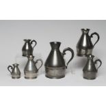 A SET OF SIX PEWTER HAYSTACK MEASURES, c.1900, stamped Austin & Son, Cork, ranging from a quart to