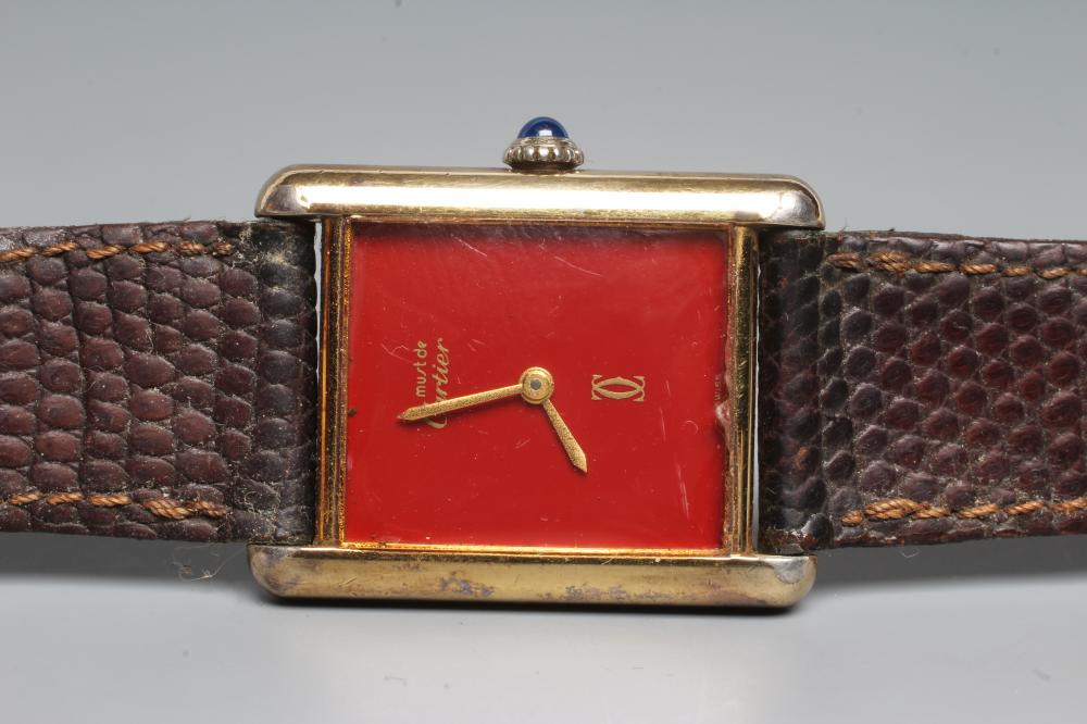 A MUST DE CARTIER SILVER GILT WRISTWATCH, the dark red oblong dial with gilt metal hour and minute