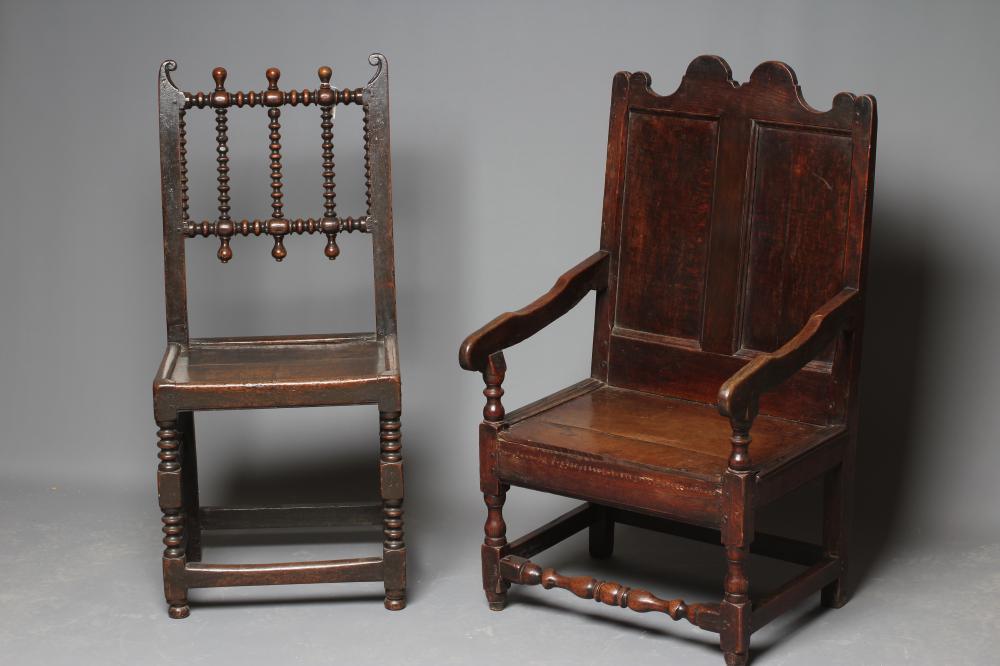 A JOINED OAK ARMCHAIR, early 18th century, the twin panelled back with waved top rail, shaped