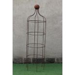 A WROUGHT IRON "WINDSOR" STYLE PLANT OBELISK of cylindrical form, the ogee top with ball finial,