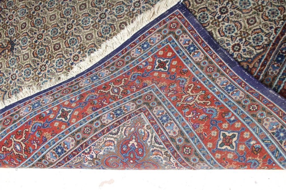 A PERSIAN RUG, the ivory field with all over repeating flowerhead and leaf pattern in shades of - Image 3 of 3