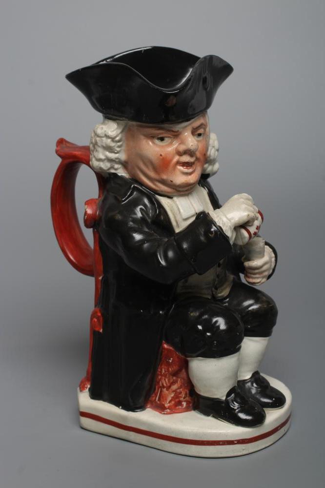 AN ENOCH WOOD TYPE EARTHENWARE DRUNKEN PARSON OR DR. JOHNSON TOBY JUG, c.1800, wearing a black