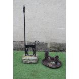 A CAST IRON BOOT SCRAPER, c. 1900, on horse shoe support, the wrythen turned square hand rest with
