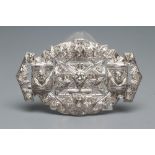 A DIAMOND OVAL OPEN PANEL BROOCH, the central open back collet set stone of approximately 0.35cts