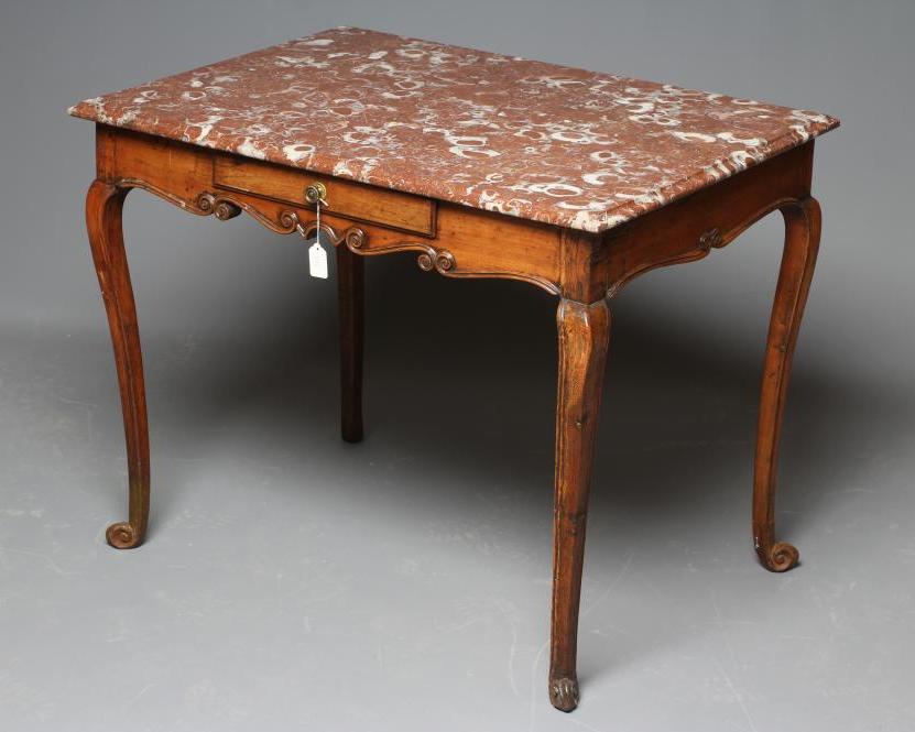 A FRENCH PROVINCIAL WALNUT CENTRE TABLE, 18th century, the oblong rouge royal marble top on scroll