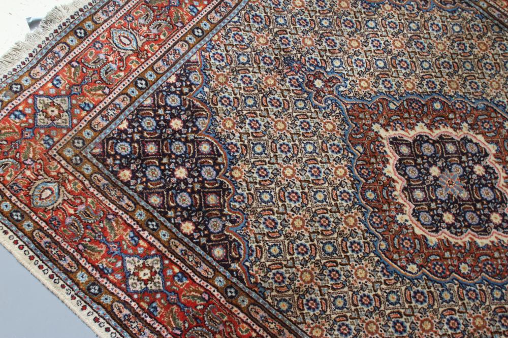 A PERSIAN RUG, the ivory floral field with central gul in red, ivory and navy blue, conforming - Image 2 of 3