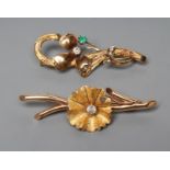A BROOCH, the matt petals centred by a claw set brilliant diamond of approximately 0.20cts on a