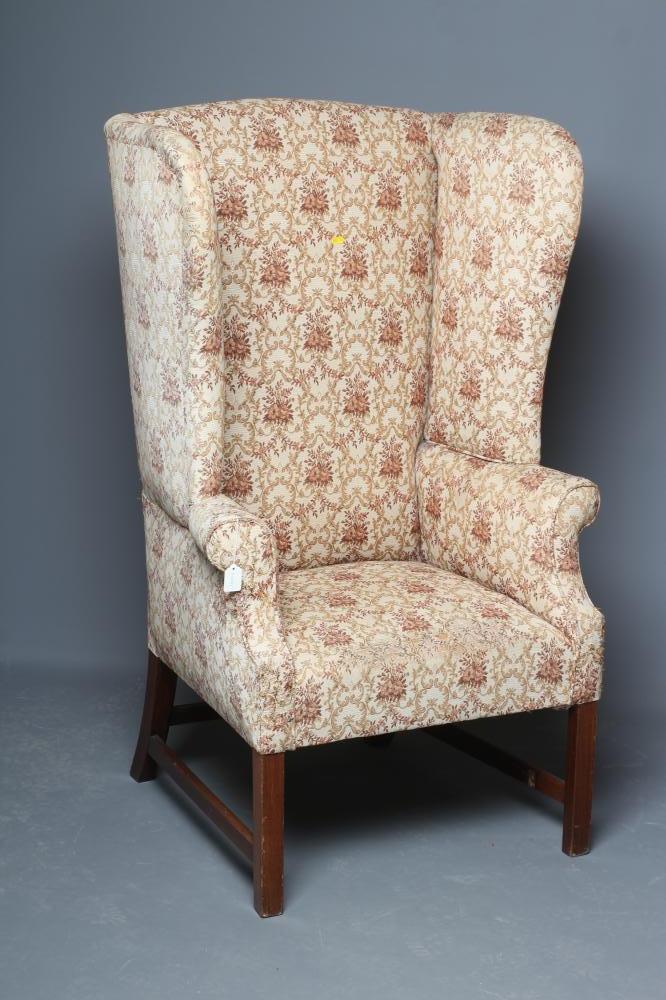 A GEORGIAN DESIGN MAHOGANY AND ELM FRAMED WING ARMCHAIR, 19th century, upholstered in a cream and