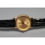 A LADY'S 18CT GOLD BAUME & MERCIER WRISTWATCH with plain dark champagne dial, seventeen jewel