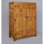 A ROBERT THOMPSON ADZED OAK DOUBLE WARDROBE of multi-panelled form with half penny moulded