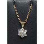 A DIAMOND CLUSTER PENDANT, the seven round brilliant cut stones claw set to a plain unmarked frame