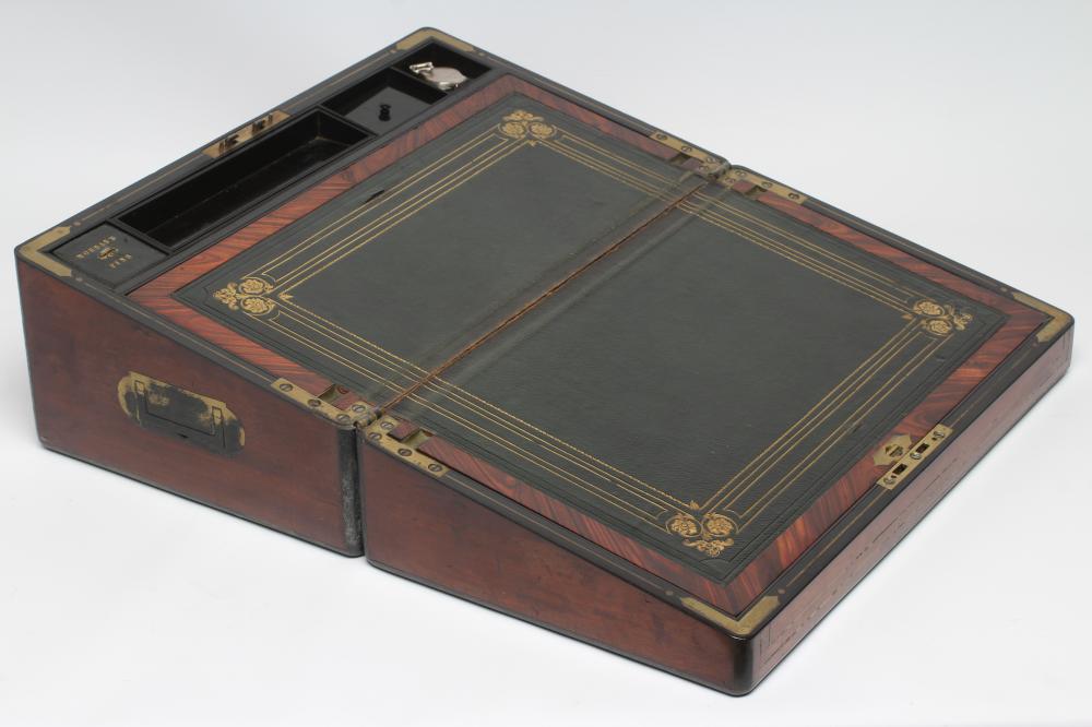 A VICTORIAN MAHOGANY AND BRASS BOUND LAP DESK, the lid inset with brass shield inscribed "Charles