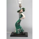 AN ART DECO GOLDSCHEIDER EARTHENWARE FIGURE modelled as a young fashionable lady wearing a wide
