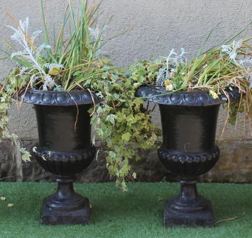 A PAIR OF CAST IRON URNS of half fluted campana form with ovolu rims, waisted socle and square base,