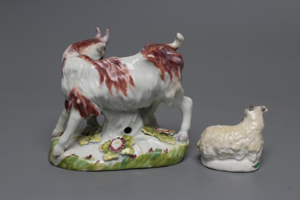 A SMALL BOW PORCELAIN SHEEP, c.1755, modelled recumbent with pale yellow fleece, on a flower painted - Image 3 of 3