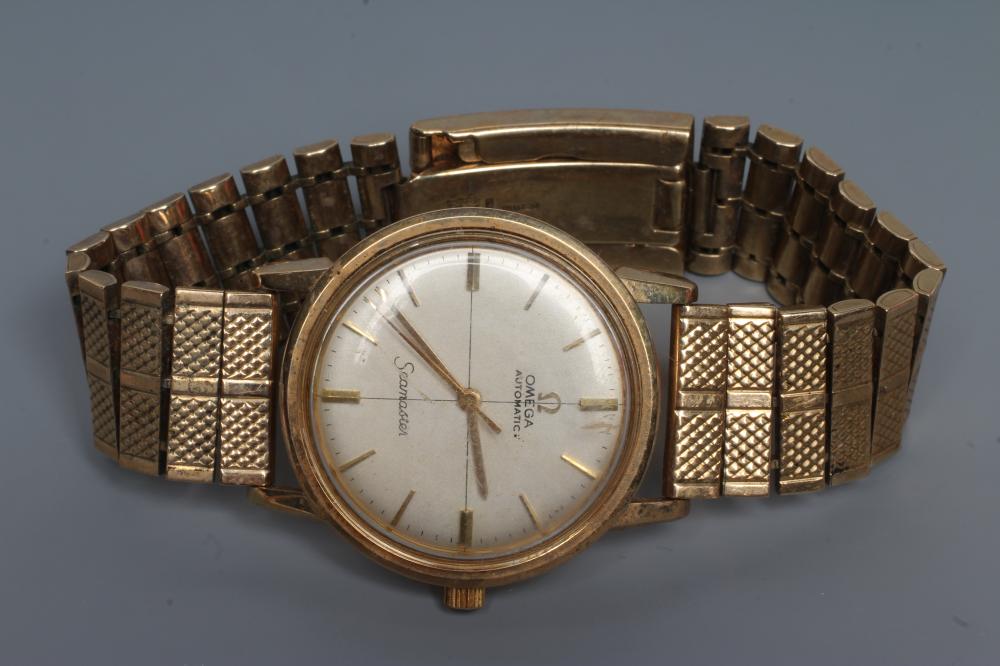 A GENTLEMAN'S 9CT GOLD OMEGA AUTOMATIC SEAMASTER WRISTWATCH, the pale champagne dial with applied