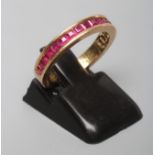 A RUBY HALF HOOP ETERNITY RING, the eighteen square cut stones channel set to a plain shank