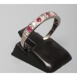 A RUBY AND DIAMOND HALF HOOP RING, the five rubies and six diamonds point set to a plain white shank