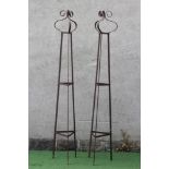 A PAIR OF WROUGHT IRON PLANT OBELISKS of tapering triangular form with scroll finials, rust