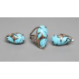 A TURQUOISE MATRIX RING, the tear polished stone asymmetrically set in unmarked white metal with