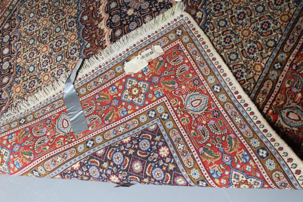 A PERSIAN RUG, the ivory floral field with central gul in red, ivory and navy blue, conforming - Image 3 of 3