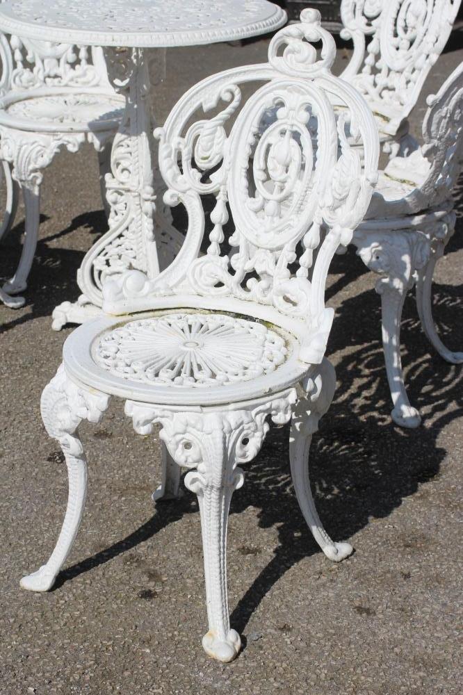 A COALBROOKDALE STYLE HEAVY CAST IRON TERRACE SUITE, comprising a circular table pierced with - Image 2 of 4