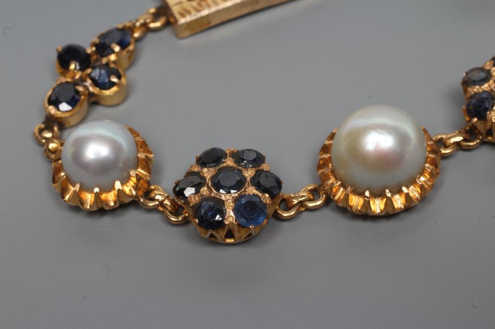 A SAPPHIRE AND PEARL BRACELET, the three graduated grey pearls set in frilled mounts between a - Image 2 of 3