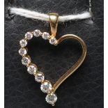 A DIAMOND HEART PENDANT, the slender open heart half set with eleven graduated stones to a fixed