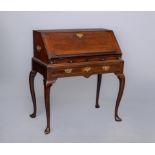 A GEORGIAN MAHOGANY BUREAU ON STAND, third quarter 18th century, the fall front with book stay,