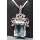 AN AQUAMARINE AND DIAMOND PENDANT, the oblong facet cut aquamarine claw set to an unmarked yellow