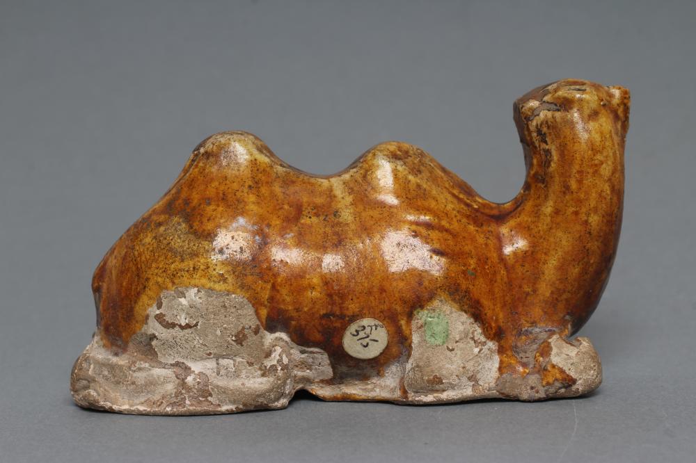 A SMALL TANG STYLE RECUMBENT CAMEL, with museum style/collectors number K61/1706 inscribed in black, - Image 2 of 3