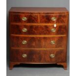 A REGENCY MAHOGANY BOW FRONT CHEST, c.1800, with boxwood stringing, the caddy top over two short and