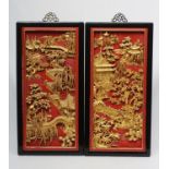 A PAIR OF CHINESE CARVED WOOD WALL PANELS, 20th century, gilded with garden scenes in high relief on