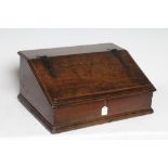 A GEORGIAN OAK BOARDED BOX DESK, mid 18th century, the moulded edge slope with wrought iron strap