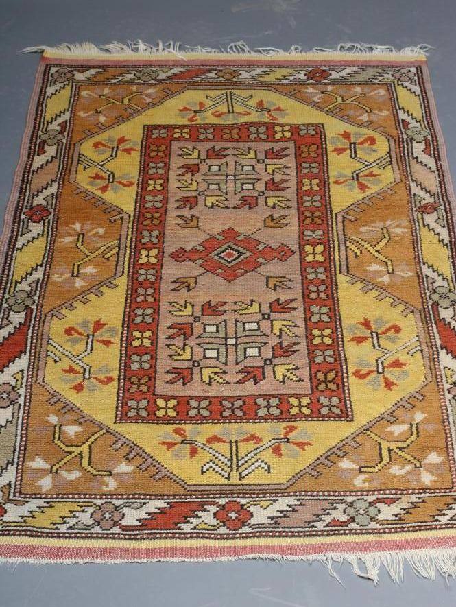 A KAZAK TYPE RUG, the oblong field with central rust coloured gul and similar border, on a bold