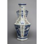 A CHINESE PORCELAIN VASE of swept octagonal form with two scrolling handles, painted in in