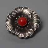 A GEORG JENSEN HOLLOW SILVER FLOWERHEAD BROOCH with polished red hardstone centre, stamped and