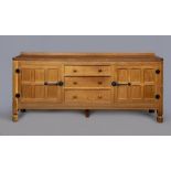 A ROBERT THOMPSON ADZED OAK ENCLOSED DRESSER, the moulded edged top with ledge back, three centre