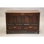 A GEORGIAN OAK PANELLED CHEST, third quarter 18th century, the moulded edged split hinged lid